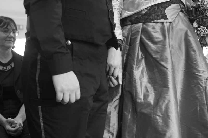 black and white picture of bride and groom holding hands