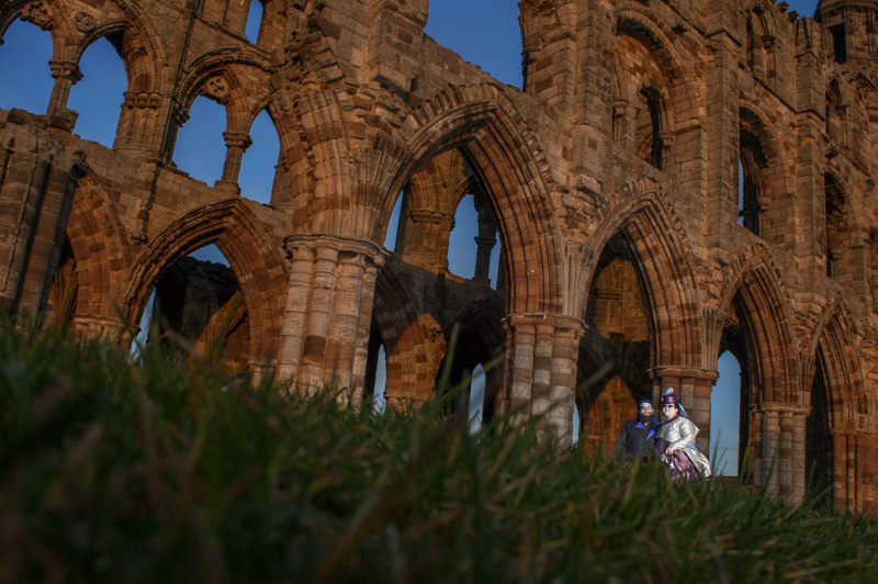 bride and groom in front of whitby abbey